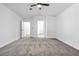 Large primary bedroom featuring neutral carpet, multiple doors, and abundant natural light at 2160 Point Mallard Dr, Henderson, NV 89012