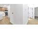Hallway with hardwood flooring, neutral paint and view of kitchen and an adjacent room at 2160 Point Mallard Dr, Henderson, NV 89012