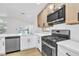 Modern kitchen featuring stainless steel appliances, quartz countertops and light wood cabinets at 2160 Point Mallard Dr, Henderson, NV 89012