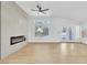 Spacious living room with fireplace, fan, backyard view, and laminate floors at 2160 Point Mallard Dr, Henderson, NV 89012