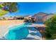 Backyard oasis features a freeform pool with a garden area, desert landscaping and privacy wall at 2160 Point Mallard Dr, Henderson, NV 89012