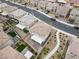 Aerial view of the home with a paved backyard, neat landscaping, and neighborhood at 2205 Stone Well Rd, North Las Vegas, NV 89031