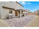 Private backyard features a stone-paved patio with a pergola and a stainless steel grill at 2205 Stone Well Rd, North Las Vegas, NV 89031