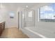 Bright bathroom featuring tile floors, a soaking tub, and a separate shower enclosure at 2205 Stone Well Rd, North Las Vegas, NV 89031
