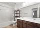 Bathroom features a tiled tub-shower combo with a double sink vanity and tiled flooring at 2205 Stone Well Rd, North Las Vegas, NV 89031