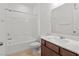 Bright bathroom featuring a tub-shower combo and vanity with a white countertop and brown cabinets at 2205 Stone Well Rd, North Las Vegas, NV 89031