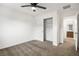 Clean bedroom showcasing carpet floors, a ceiling fan, closet with sliding doors and a door to the bathroom at 2205 Stone Well Rd, North Las Vegas, NV 89031