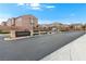 Gated community entrance featuring well maintained landscaping and signage under a bright blue sky at 2205 Stone Well Rd, North Las Vegas, NV 89031