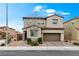 Charming two-story home with a well-manicured front yard, desert landscaping, and an attached two-car garage at 2205 Stone Well Rd, North Las Vegas, NV 89031