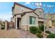Inviting home exterior with stone accents, a covered entry, and landscaped walkway at 2205 Stone Well Rd, North Las Vegas, NV 89031