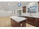 Bright, well-equipped kitchen with quartz countertops, an island, and sliding glass doors to the backyard at 2205 Stone Well Rd, North Las Vegas, NV 89031