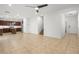 Open-concept living room with tile floors, recessed lighting, and seamless transition to the adjacent kitchen area at 2205 Stone Well Rd, North Las Vegas, NV 89031