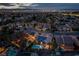 Night aerial shot of community highlighting city lights and homes with pools at 2287 Moresca Ave, Henderson, NV 89052