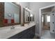 Bathroom featuring double sinks, gray cabinets, and hallway access at 2287 Moresca Ave, Henderson, NV 89052