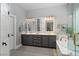 Elegant bathroom with double sinks, soaking tub, and ample counter space at 2287 Moresca Ave, Henderson, NV 89052