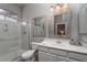 Modern bathroom with a glass-enclosed shower and a double vanity with framed mirrors at 2287 Moresca Ave, Henderson, NV 89052