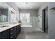 Bathroom featuring a large soaking tub, separate shower, and dual sink vanity at 2287 Moresca Ave, Henderson, NV 89052