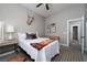 Cozy bedroom featuring a white bedspread, textured rug, and mounted stag head decoration at 2287 Moresca Ave, Henderson, NV 89052