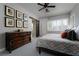 Cozy bedroom with accent wall art and dark wood dresser at 2287 Moresca Ave, Henderson, NV 89052