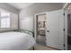 Comfortable bedroom with a green metal bed frame, closet, and bathroom access at 2287 Moresca Ave, Henderson, NV 89052