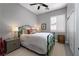 Charming bedroom with a green metal bed frame, white bedding, and a neutral color scheme at 2287 Moresca Ave, Henderson, NV 89052