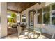 Inviting covered patio offers a relaxing outdoor dining area, ceiling fan, and views of the lush, green backyard at 2287 Moresca Ave, Henderson, NV 89052