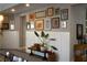 Elegant hallway featuring a gallery wall with a variety of framed pictures at 2287 Moresca Ave, Henderson, NV 89052