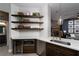 Stylish kitchen with wine fridge, open shelving, and a view into the adjacent living area at 2287 Moresca Ave, Henderson, NV 89052