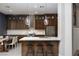 Open kitchen features a large island with seating, pendant lighting, and stainless steel appliances at 2287 Moresca Ave, Henderson, NV 89052