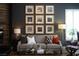 Stylish living room featuring an elegant couch, striking artwork, and window shutters at 2287 Moresca Ave, Henderson, NV 89052