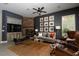 Inviting living room with a decorative ceiling fan, comfortable seating, and a cozy fireplace at 2287 Moresca Ave, Henderson, NV 89052