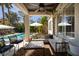 Relaxing covered patio with comfortable seating, overlooks a sparkling pool and lush backyard at 2287 Moresca Ave, Henderson, NV 89052