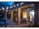Cozy covered patio with comfortable seating, decorative lighting, and serene pool views, ideal for relaxing and entertaining guests at 2287 Moresca Ave, Henderson, NV 89052