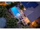 Aerial view of a private backyard oasis featuring a sparkling pool, lounge area, umbrella, and solar panels on the roof at 2287 Moresca Ave, Henderson, NV 89052