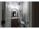 Stylish half bathroom boasting custom mirror, sleek fixtures, and artistic wall accents for a touch of elegance at 2287 Moresca Ave, Henderson, NV 89052