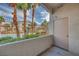 Balcony view of the community pool surrounded by palm trees and lush landscaping at this condominium at 2305 W Horizon Ridge Pkwy # 514, Henderson, NV 89052