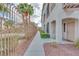 A sidewalk view of the apartment building with an iron fence and palm trees at 2305 W Horizon Ridge Pkwy # 514, Henderson, NV 89052