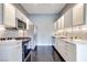 Spacious kitchen featuring stainless steel appliances, white cabinets, and a modern backsplash at 2305 W Horizon Ridge Pkwy # 514, Henderson, NV 89052