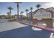 Entrance to the Mission Hills Condominiums featuring lush landscaping and mature palm trees at 2305 W Horizon Ridge Pkwy # 514, Henderson, NV 89052