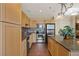 Bright kitchen featuring granite countertops, stainless steel appliances, tile backsplash, and stylish light fixture at 2405 W Serene Ave # 631, Las Vegas, NV 89123