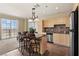 Well-lit kitchen features tile flooring, granite countertops, stainless steel appliances, and breakfast bar seating at 2405 W Serene Ave # 631, Las Vegas, NV 89123