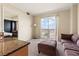 Comfortable living room space featuring a view from the large window, and neutral toned walls and carpet at 2405 W Serene Ave # 631, Las Vegas, NV 89123