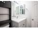 Bathroom featuring gray vanity with white countertop and modern fixtures, plus black shelving at 2430 Old Forge Ln # 106, Las Vegas, NV 89121