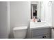 Cozy half-bathroom with white countertops and cabinets below the sink at 2430 Old Forge Ln # 106, Las Vegas, NV 89121