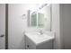 Bathroom with a white vanity featuring a light gray base, and a large mirror at 2430 Old Forge Ln # 106, Las Vegas, NV 89121