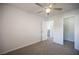 View of bedroom with neutral carpet, ceiling fan, and doorways to the hall and closet at 2430 Old Forge Ln # 106, Las Vegas, NV 89121