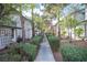 Well-kept community walkway lined with manicured hedges and mature trees at 2430 Old Forge Ln # 106, Las Vegas, NV 89121