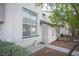 Inviting townhome with white stucco, green accents, and a secure gated entrance at 2430 Old Forge Ln # 106, Las Vegas, NV 89121