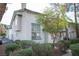 Attractive townhome featuring a tiled roof, secure entrance, and well-maintained landscaping at 2430 Old Forge Ln # 106, Las Vegas, NV 89121