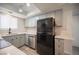 Well-lit kitchen boasts stainless steel appliances, gray cabinets, and white countertops at 2430 Old Forge Ln # 106, Las Vegas, NV 89121